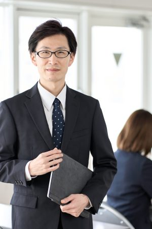 Asian businessman with tablet in seminar room
